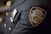 FILE- A detail including the badge and shield of one of the newest members of the New York City police is seen during his graduation ceremony, Thursday, June 29, 2017, in New York.  (AP Photo/Mary Altaffer, file)