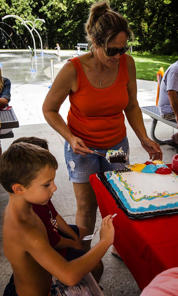 Shari cuts the cake for the birthday boy 